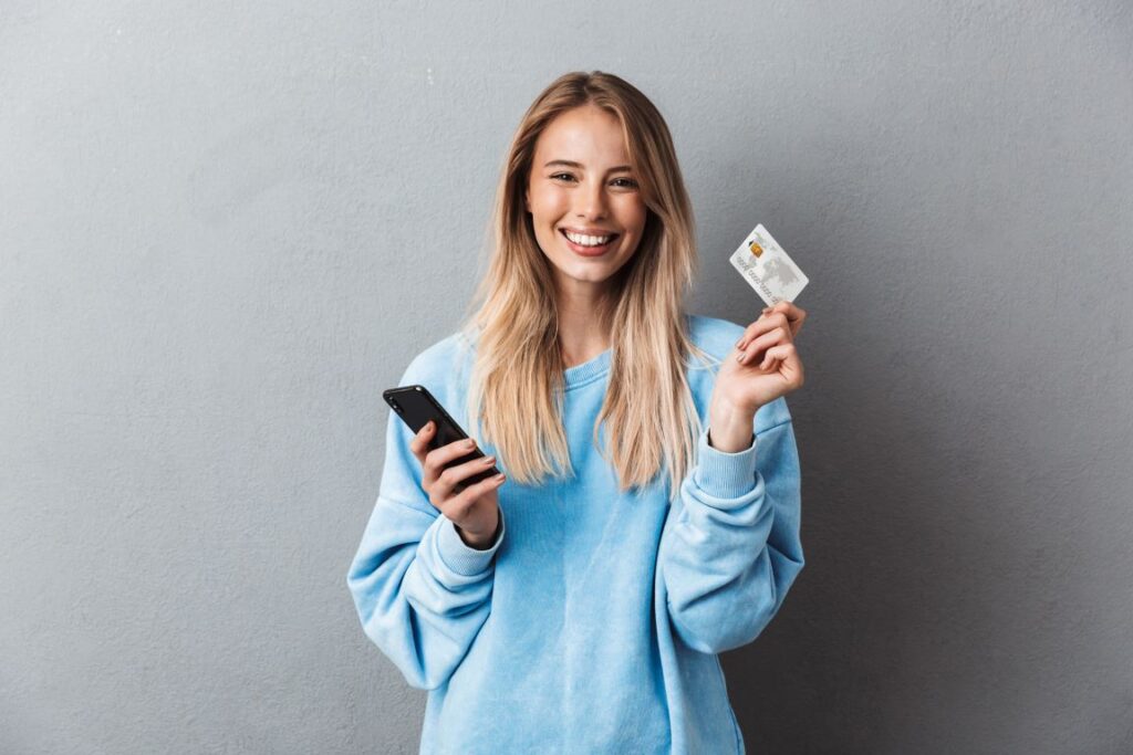 young girl teen holding debit card