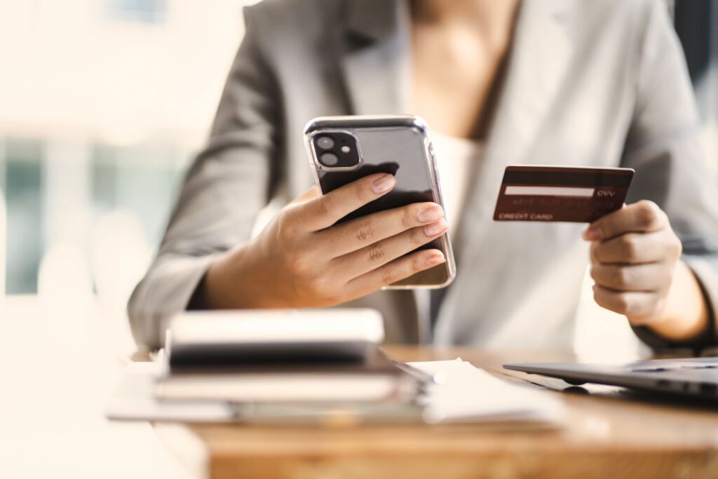 Woman holding a phone and credit card